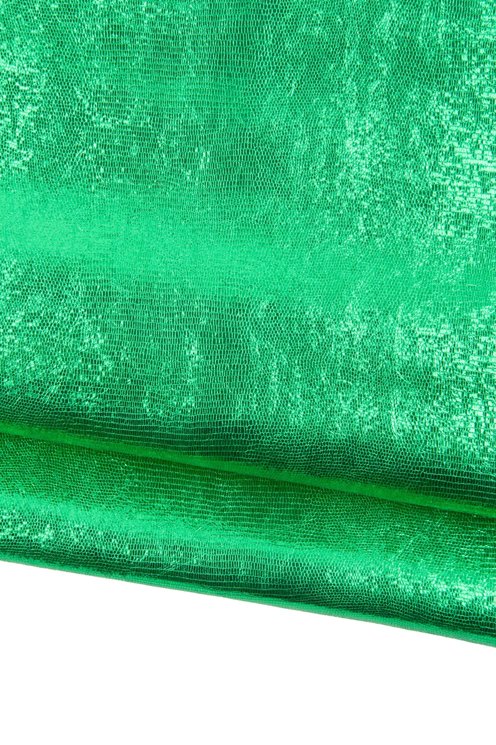 May include: Close-up of a vibrant green fabric with a textured, reptile-like pattern. The material has a metallic sheen, reflecting light and creating a shimmering effect. The fabric is folded, revealing its layered structure.