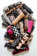 Può includere: Una collezione di ritagli di pelle colorati e con motivi, tra cui stampe zebrate, leopardo e ghepardo, oltre a quadri e colori solidi. I ritagli sono arrotolati e disposti in una pila.
